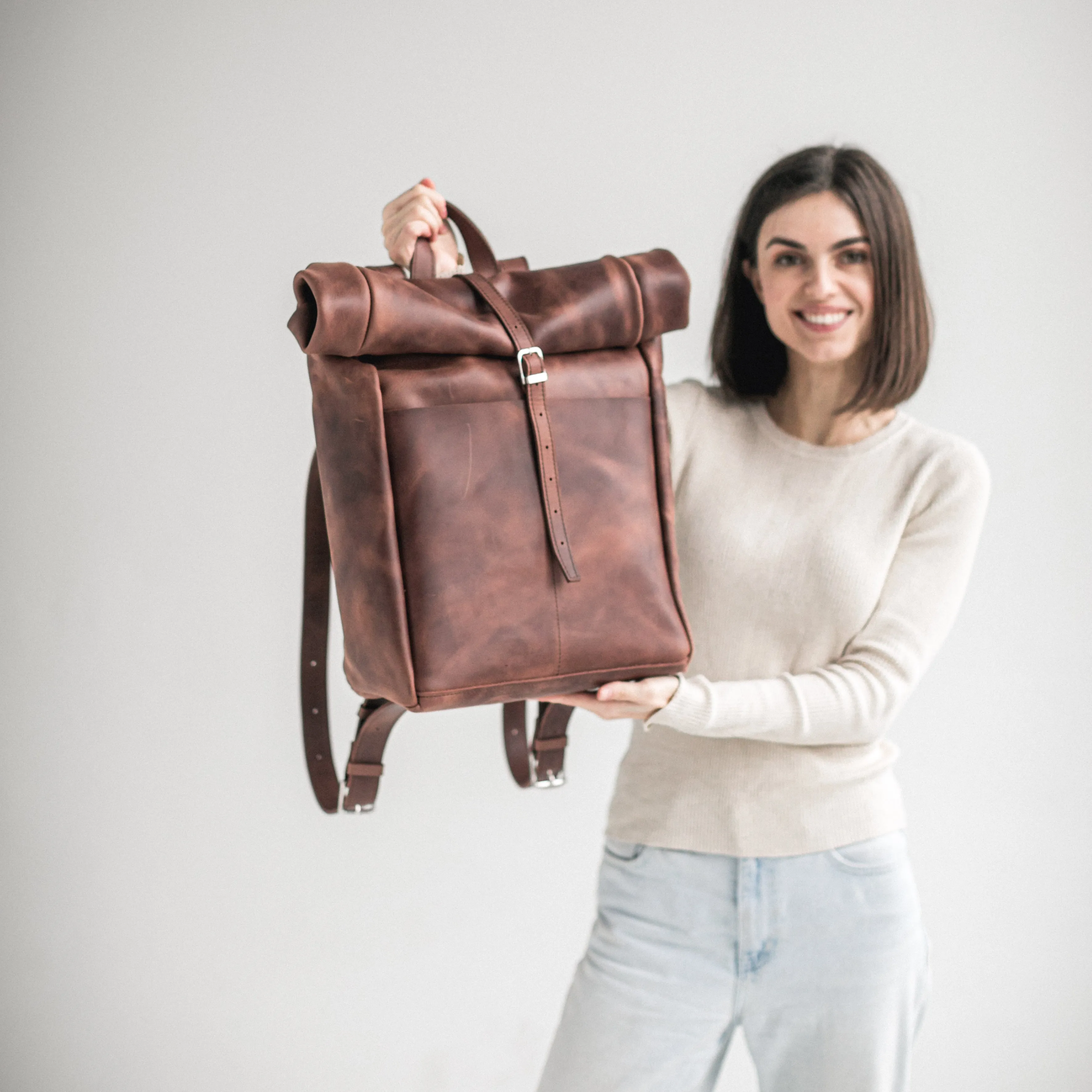 Whiskey brown leather roll-top backpack